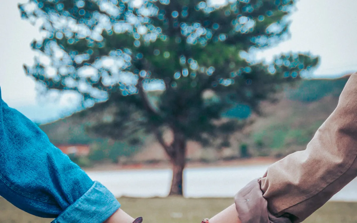 A couple holding hands outdoors