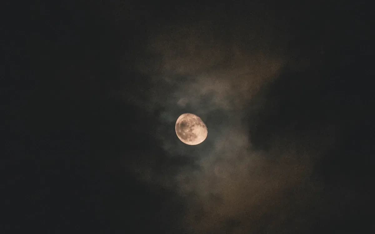 A full moon glowing in a dark night sky
